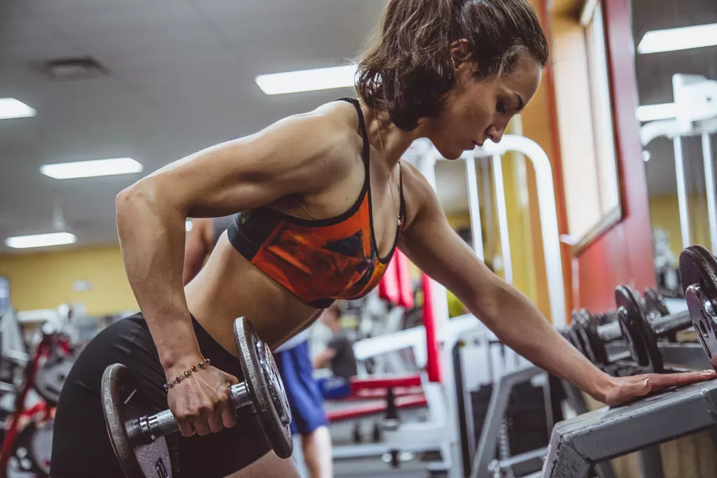 mujer haciendo ejercicios de tríceps con peso สิบโท